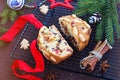 A traditional Scottish Christmas fruit mini Dundee cake with a mix of dried fruits, decorated with peeled almonds, on a black wire