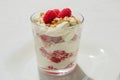 Classic Scottish Cranachan dessert with toasted oats, fresh raspberries, whipped cream and whisky in a glass
