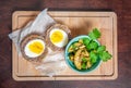 Traditional Scottish meat cutlet with boiled eggs, cucumber and fresh parsley. Top view