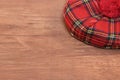 Traditional Scottish Red Tartan Bonnet on Wood Board Royalty Free Stock Photo