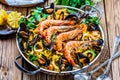 Seafood Paella in the man on a white table with decoration