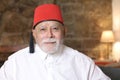 Traditional senior Arabic man wearing religious hat