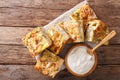 Traditional Serbian Gibanica with cheese, eggs and greens close-up and yogurt. horizontal top view