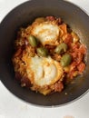 Traditional shakshuka with eggs and olives