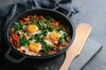 Traditional shakshuka with eggs, tomato, and parsley