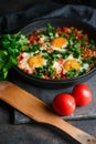 Traditional shakshuka with eggs, tomato, and parsley