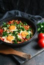 Traditional shakshuka with eggs, tomato, and parsley