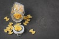 Traditional shape of dry uncooked whole wheat Italian pasta in glass jar Royalty Free Stock Photo