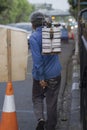 A traditional sharpen knife service carries the sharpening tools on his shoulder