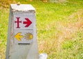 Traditional shell sign and arrow painted on the way. Direction sign for pilgrims in Saint James way, Camino de Santiago de Royalty Free Stock Photo