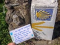 Traditional shell sign and arrow painted on the way. Direction sign for pilgrims in Saint James way, Camino de Santiago