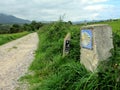 Traditional shell sign and arrow painted on the way. Direction sign for pilgrims in Saint James way, Camino de Santiago Royalty Free Stock Photo