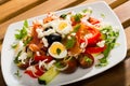 Shepherd's salad with salmon, fresh tomato, cucumber and quail eggs