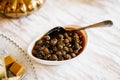 Traditional Siberian dessert - Jam of young pine cones. Selective focus. Jam of fir cones in a plate on the table Royalty Free Stock Photo