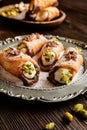 Traditional Sicilian cannoli stuffed with ricotta and pistachios