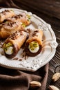 Traditional Sicilian cannoli stuffed with ricotta and pistachios