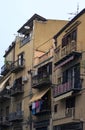 Traditional Sicilian street with old residential house. Underwear drying on the balcony fence. Typical architecture of houses