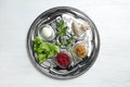 Traditional silver plate with symbolic meal for Passover Pesach Seder on wooden background