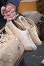 Traditional skill of manual making of Dutch wooden shoes or clogs on a market in the Netherlands