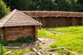 Traditional Slavic Russian Belarus rustic country round log house and a fence building process. A photo in summer sunny Royalty Free Stock Photo