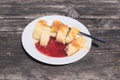 Traditional Slovene Struklji with strawberry jam an white plate,