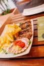 Traditional slovenian cuisine, meat kebab - chevapchichi - with french fries. Selective focus Royalty Free Stock Photo