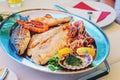 Traditional slovenian cuisine, mixed grilled fish and seafood with garlic oil. Selective focus