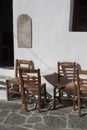 Tables and chairs at the entrance to a traditional Greek cafe on the island of Folegandros/ Royalty Free Stock Photo