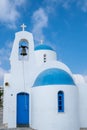 Traditional small christian church against blue cloudy sky