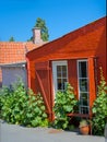 a traditional small,red,danish framehouse in summer in Bornholm with blue sky Royalty Free Stock Photo