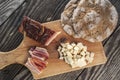 Snack with delicious South Tyrolean smoked bacon and cheese with flat bread lying on a rustic table Royalty Free Stock Photo