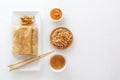Traditional snacks of Chinese cuisine Dim Sum - tortillas - bings in a plate on a white background, spicy salads, vegetables