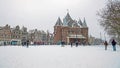 Traditional snowy Waag building at the Nieuwmarkt in Amsterdam in the Netherlands in winter