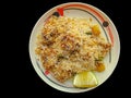 Traditional south Indian Basmati kacchi biryani with mutton and a lemon. Basmati kacchi with black background