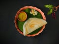 Traditional south indian food masala dosa, sambar and coconut chutney served on clay plate and banana leaf. studio shot Royalty Free Stock Photo