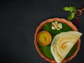 Traditional south indian food masala dosa, sambar and coconut chutney served on clay plate and banana leaf. studio shot