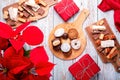 Traditional Spanish Christmas sweets turron, polvorones, mantecados with Christmas decor and red gift boxes on light Royalty Free Stock Photo