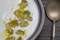 Traditional Spanish dish, cold soup ajo blanco or ajoblanco from garlic, almonds, white wine vinegar, olive oil and grapes Royalty Free Stock Photo