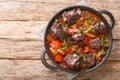 Traditional spanish dish slow cooked oxtail in red wine sauce with rabo de toro closeup on a pot on the table. Horizontal top view Royalty Free Stock Photo