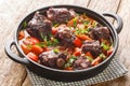 Traditional spanish dish slow cooked oxtail in red wine sauce with rabo de toro closeup on a pot on the table. Horizontal Royalty Free Stock Photo