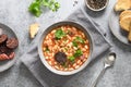 Spanish asturiana fabada on gray table. Top view.