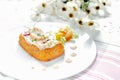 Traditional Spanish fish cake. Hake cake with tomato, shrimps and salad cream.