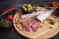 Traditional Spanish fuet salami sausage on wooden cutting board at domestic kitchen Royalty Free Stock Photo