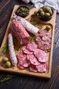 Traditional Spanish fuet salami sausage on wooden cutting board at domestic kitchen Royalty Free Stock Photo