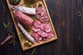 Traditional Spanish fuet salami sausage on wooden cutting board at domestic kitchen Royalty Free Stock Photo