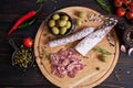 Traditional Spanish fuet salami sausage on wooden cutting board at domestic kitchen Royalty Free Stock Photo