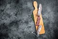 Traditional Spanish Fuet thin dried sausage with sliceson the wooden board. top view. Royalty Free Stock Photo