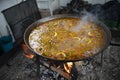 Traditional Spanish paella cooking over open flames at a beach restaurant at Nerja. Spain. Royalty Free Stock Photo
