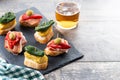 Traditional Spanish pintxos on wooden table Royalty Free Stock Photo