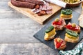 Traditional Spanish pintxos on wooden table Royalty Free Stock Photo